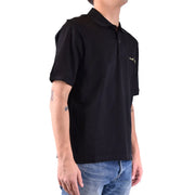 Polo Saint Laurent en coton noir pour homme, avec logo brodé doré sur la poitrine, vue de face