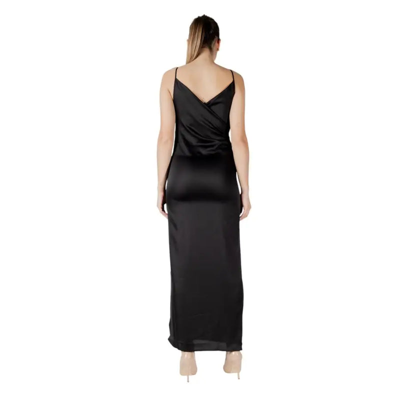 Back view of sleeveless black satin maxi dress with crossed-back design in elegant slip style