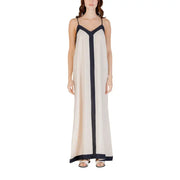 A flowing off-white sleeveless floor length maxi dress with navy blue vertical stripe and matching straps