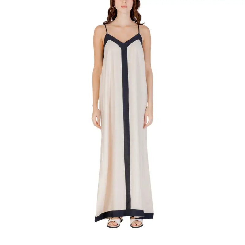 A flowing off-white sleeveless floor length maxi dress with navy blue vertical stripe and matching straps
