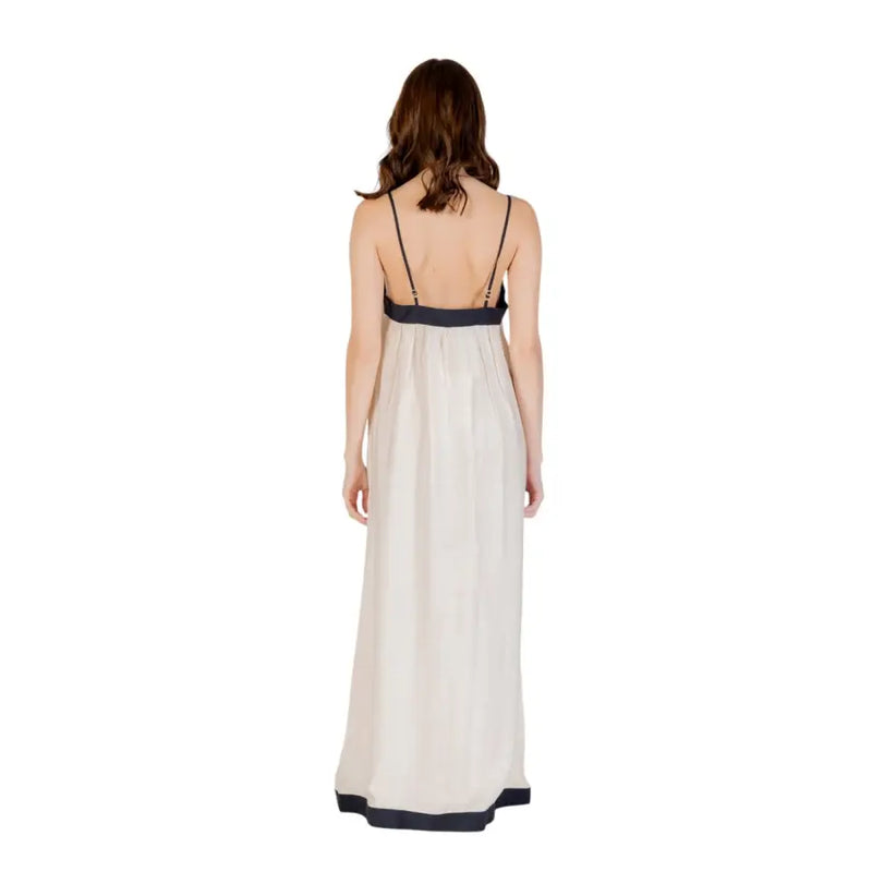 Beige silk sleeveless floor length dress with thin spaghetti straps and black trim for elegant occasions