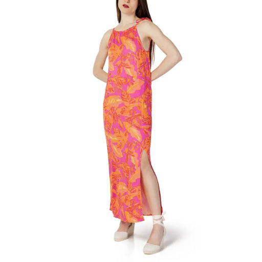 A vibrant pink and orange tropical leaf print sleeveless lace dress in 100% viscose for spring and summer