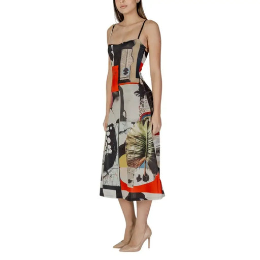Sleeveless midi dress with abstract patchwork print displayed on product page