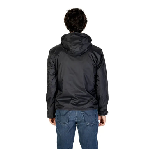 Men’s black hooded windbreaker jacket paired with blue jeans displayed with sophisticated tailored blazer in premium fabric