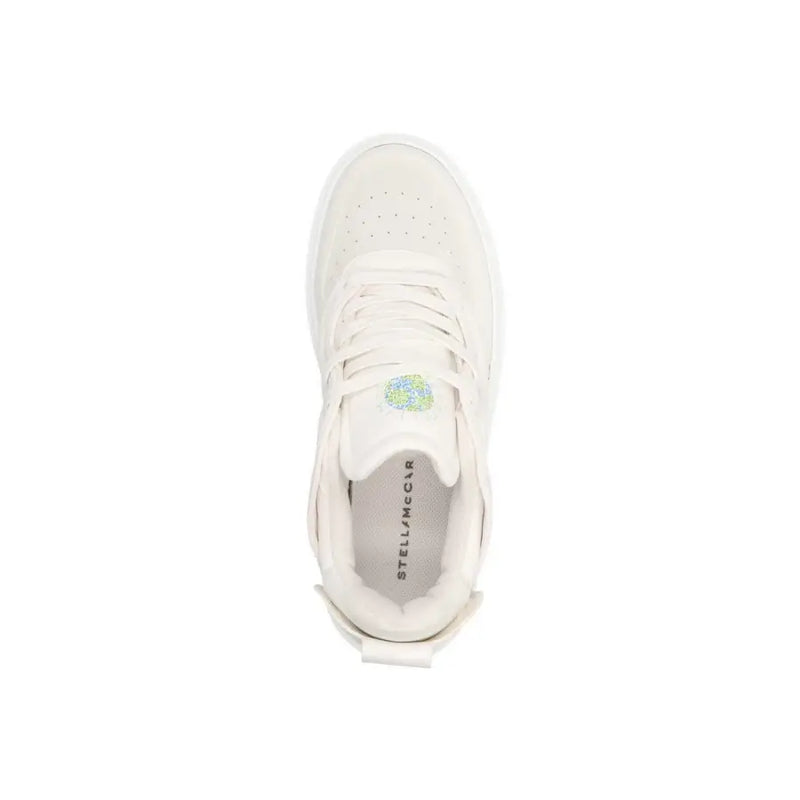 Baskets blanches Stella McCartney en cuir à enfiler pour femme, avec tige perforée et semelle épaisse.