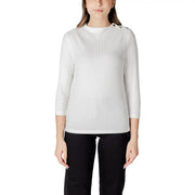 Woman wearing a white ribbed knit top with decorative shoulder buttons from Street One
