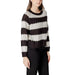 Women’s striped knit sweater displayed with black pants in a fashion product image