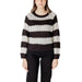 Women’s striped knit sweater paired with black pants for a stylish look