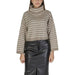 Beige striped turtleneck sweater paired with a black skirt for women’s fall and winter fashion