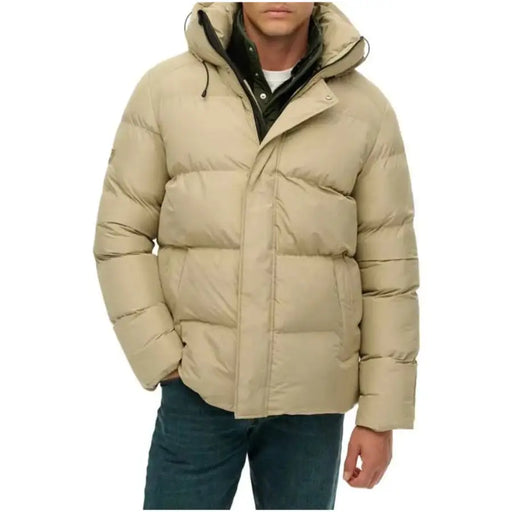 Beige puffer jacket with hood and black accents, likely made of synthetic material.