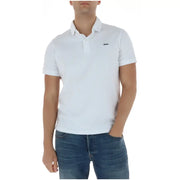 Polo Lacoste blanc à manches courtes en coton, orné d'un discret logo crocodile vert, pour homme.