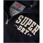 Dark navy blue superdry men sweatshirt with cream embroidered lettering and vintage-style brand label in cotton