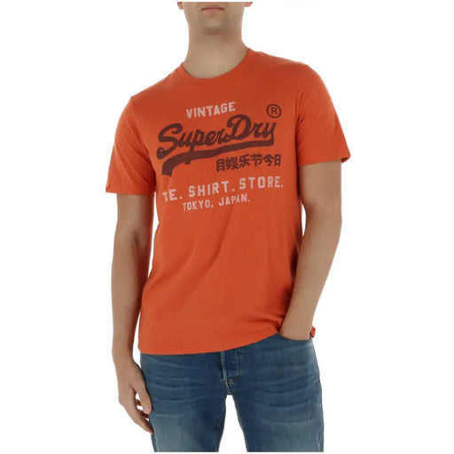 Superdry T-shirt homme orange en mélange de coton à manches courtes avec imprimé graphique vintage noir et détails en T, modèle M1012216A