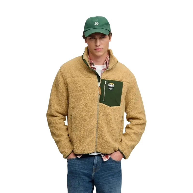 Superdry Sweat-shirt polaire jaune à fermeture éclair intégrale pour homme, doublé de polaire couleur camel, poche poitrine et tirette de fermeture éclair vert foncé.