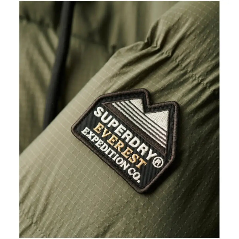 Superdry women green hooded zip jacket made of olive green durable fabric with everest expedition co logo on the front