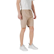 Tan drawstring shorts made of beige cotton with a drawstring waistband and subtle side pockets for casual wear