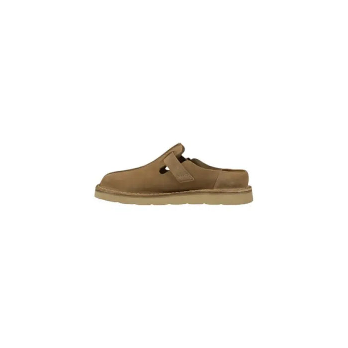 Tan suede clog with buckle detailing displayed in the product image