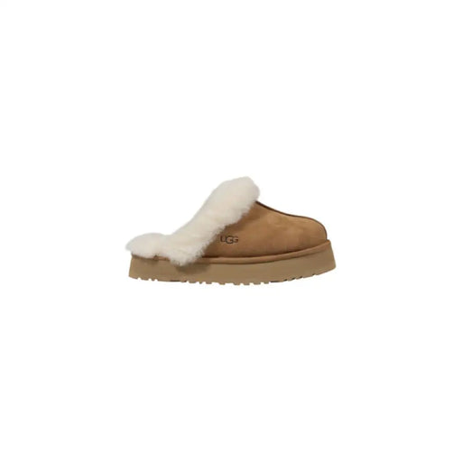 Tan UGG slipper with plush white fur trim for luxurious comfort and style