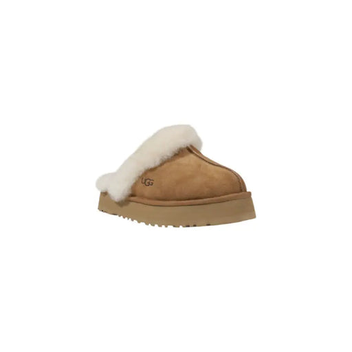 Tan UGG slipper with white fur trim showcasing cozy and stylish footwear