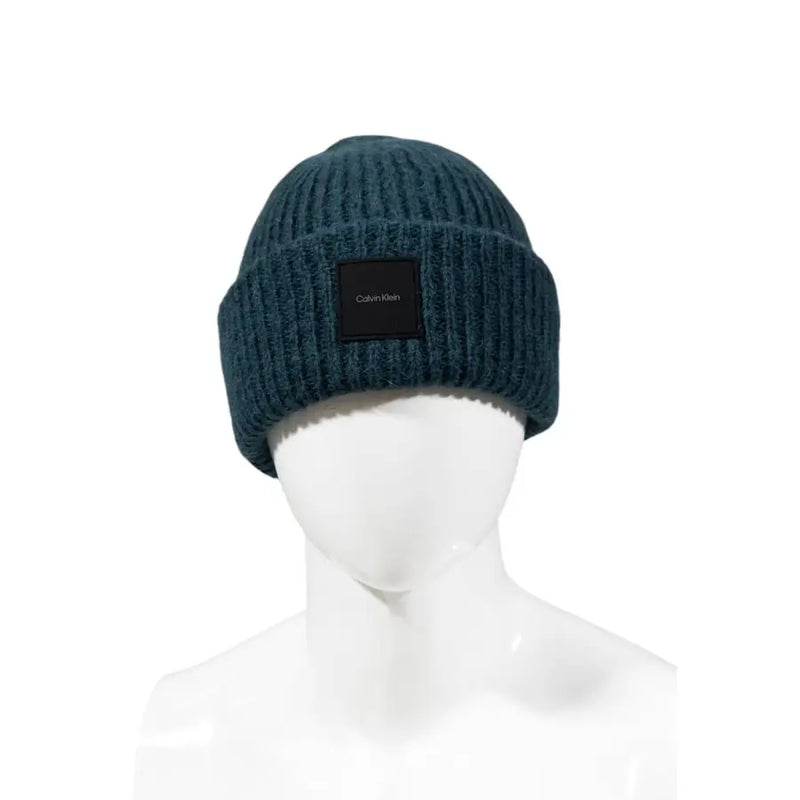 Dark teal ribbed knit beanie made of warm fabric featuring a black calvin klein logo patch for stylish wear