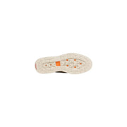 Timberland men lace up beige suede shoes with white rubber sole featuring orange diamond accents and textured tread