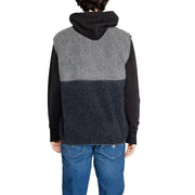Charcoal and gray sherpa vest with black hooded sweatshirt underneath.