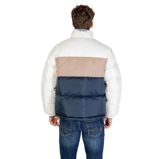 Three-toned puffer jacket with beige, navy blue and white panels.