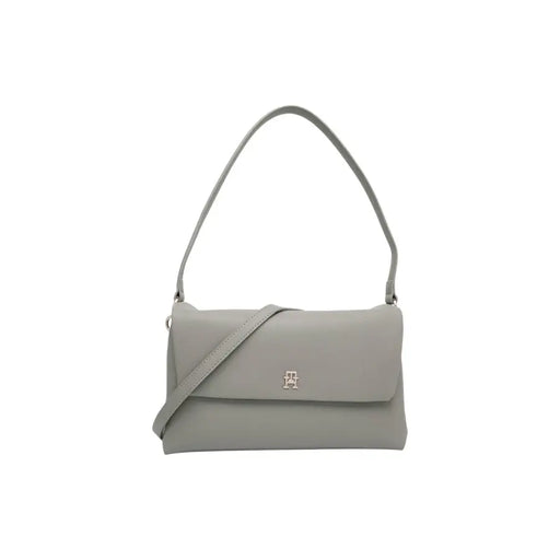 Light grey Tommy Hilfiger shoulder bag with front flap closure and silver emblem