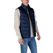 Gilet matelassé bleu marine avec fermeture éclair noire et Tommy Hilfiger Jeans veste sans manches pour homme avec logo sur le col