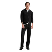 Polo noir à manches longues et coupe ajustée, orné d'un petit logo brodé, en coton biologique. Tommy Hilfiger Jeans