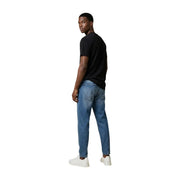 A pair of medium-wash blue denim jeans with a classic straight-leg cut from Tommy Hilfiger men collection