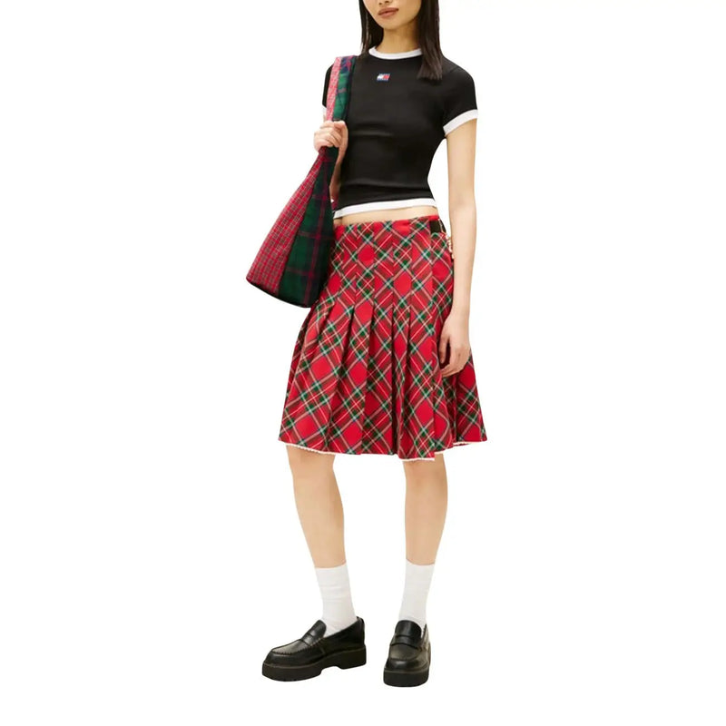 Red plaid pleated skirt with green and black accents paired with tommy hilfiger jeans women black organic cotton t-shirt