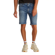 Blue denim shorts with rolled hem and white sneakers.