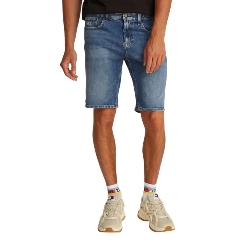 Blue denim shorts with rolled hem and white sneakers.