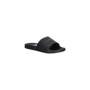 Sandales Tommy Hilfiger noires en polyuréthane, au design minimaliste et au logo discret sur la bride, pointure 41.