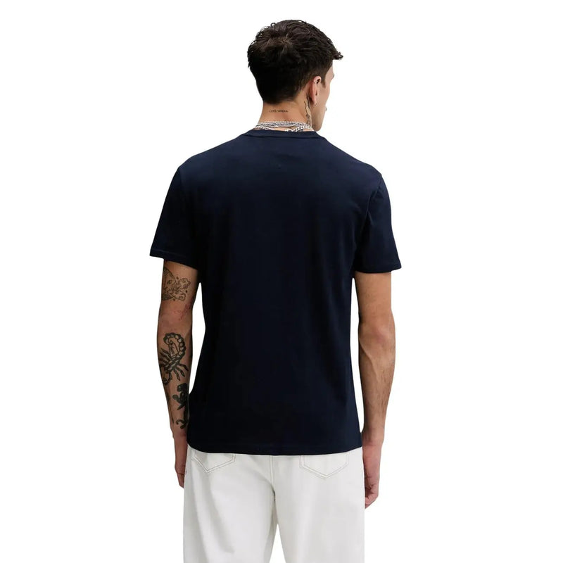 Tommy Hilfiger T-shirt homme bleu en coton bio, col rond, manches courtes et coutures latérales discrètes.