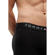 Black tommy hilfiger men boxer briefs made of organic cotton with white logo and red white blue flag emblem on waistband