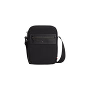 Sac reporter mini Tommy Hilfiger pour homme en similicuir noir, avec panneau avant texturé et fermeture éclair, largeur 15 cm.