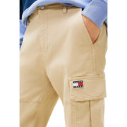 Beige Tommy Hilfiger Jeans men trousers with cargo pockets featuring a prominent Tommy Jeans logo patch