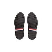 Mocassins verts en cuir Tommy Hilfiger pour homme, semelles en caoutchouc noir et rayures rouges, blanches et bleues à l'arrière.