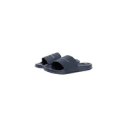 Sandales mules Tommy Hilfiger pour homme, bleu marine foncé, au design minimaliste et au logo blanc discret, en polyuréthane.