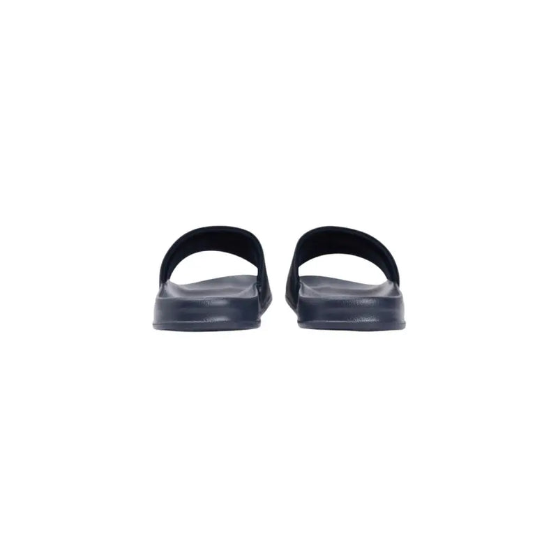 Tommy Hilfiger Sandales mules noires en caoutchouc pour homme, au design minimaliste et à bout ouvert. Tige en polyuréthane.