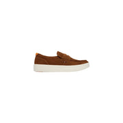 Brown suede slip-on loafer with white rubber sole and orange heel tab from tommy hilfiger men suede moccassin camel shoes