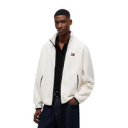 Veste polaire blanche duveteuse en polyester, avec fermeture éclair et finitions noires, ornée du logo Tommy Hilfiger sur la poitrine gauche.