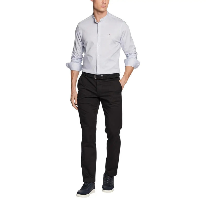 Light gray tommy hilfiger men button-down shirt with rolled-up sleeves and subtle chest logo paired with trousers