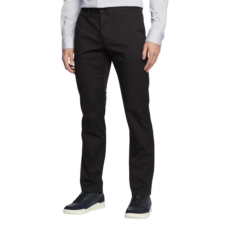 Black tailored Tommy Hilfiger men trousers with sleek straight-leg cut and subtle creases in premium fabric