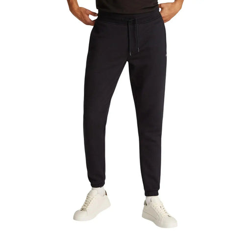 Pantalon de jogging slim en molleton de coton noir par Tommy Hilfiger avec une taille élastiquée à cordon et des poignets côtelés en matière polaire douce
