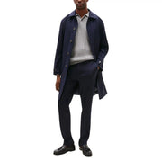 Navy blue wool overcoat with button closures and classic collar featured with Tommy Hilfiger men trousers