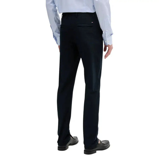 Pantalon de costume noir Tommy Hilfiger pour homme, coupe ajustée, dos dévoilant le dos, avec une ceinture discrète ornée d'un logo rouge, blanc et bleu.