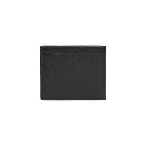 Tommy Hilfiger Portefeuille homme en cuir noir à la texture subtile et aux coutures précises, pour un usage quotidien.